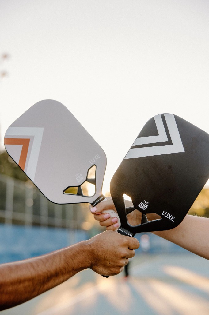 Two players tapping paddles together after a point