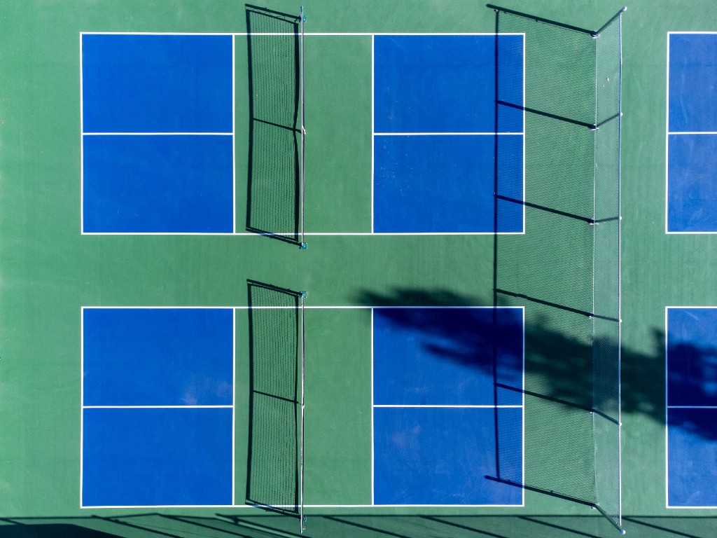 Overhead view of blue and green pickleball courts